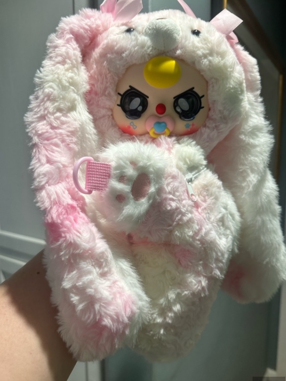 Baby three backpack with pacifier and crying eyes